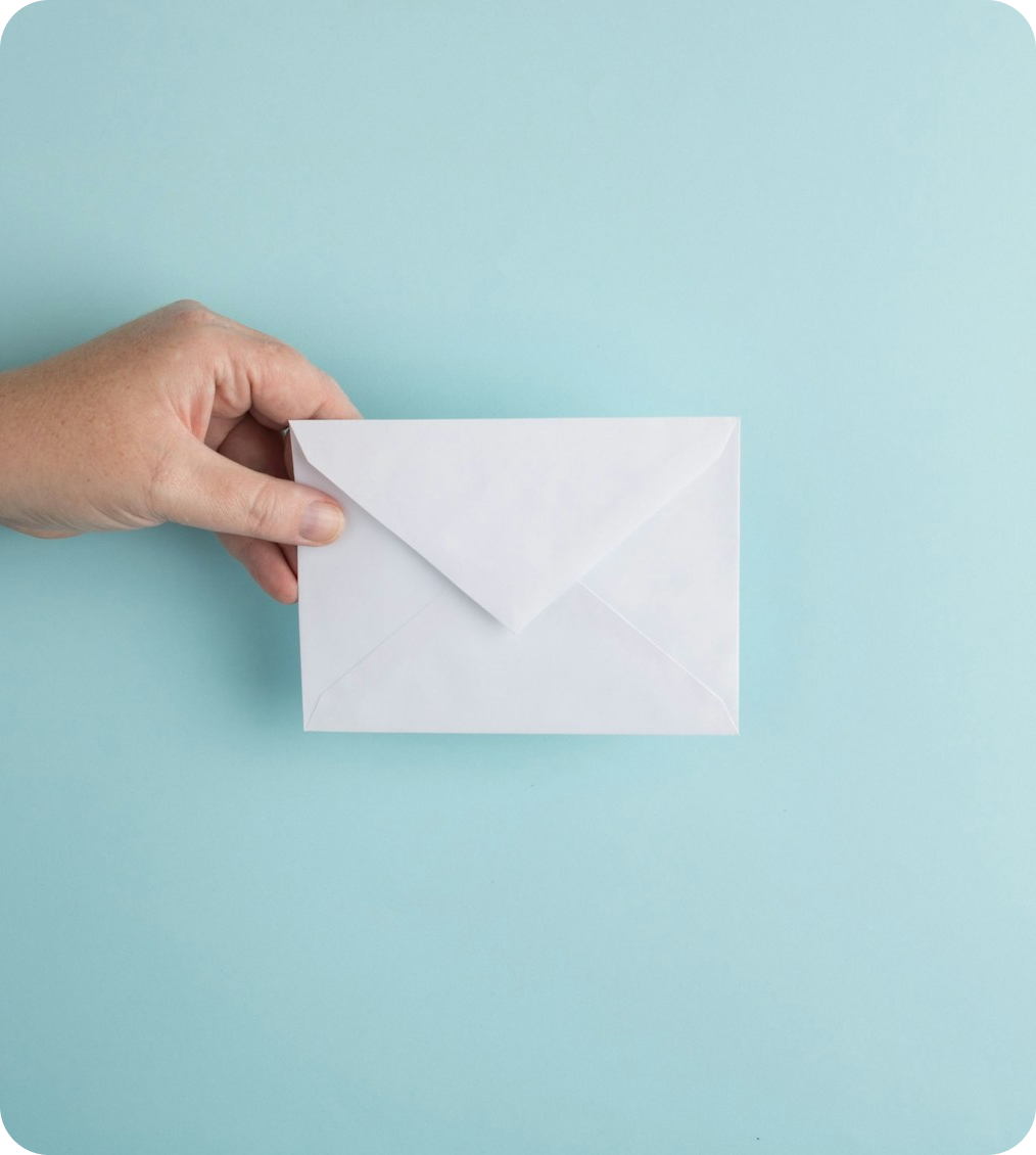 A hand holding an envelope